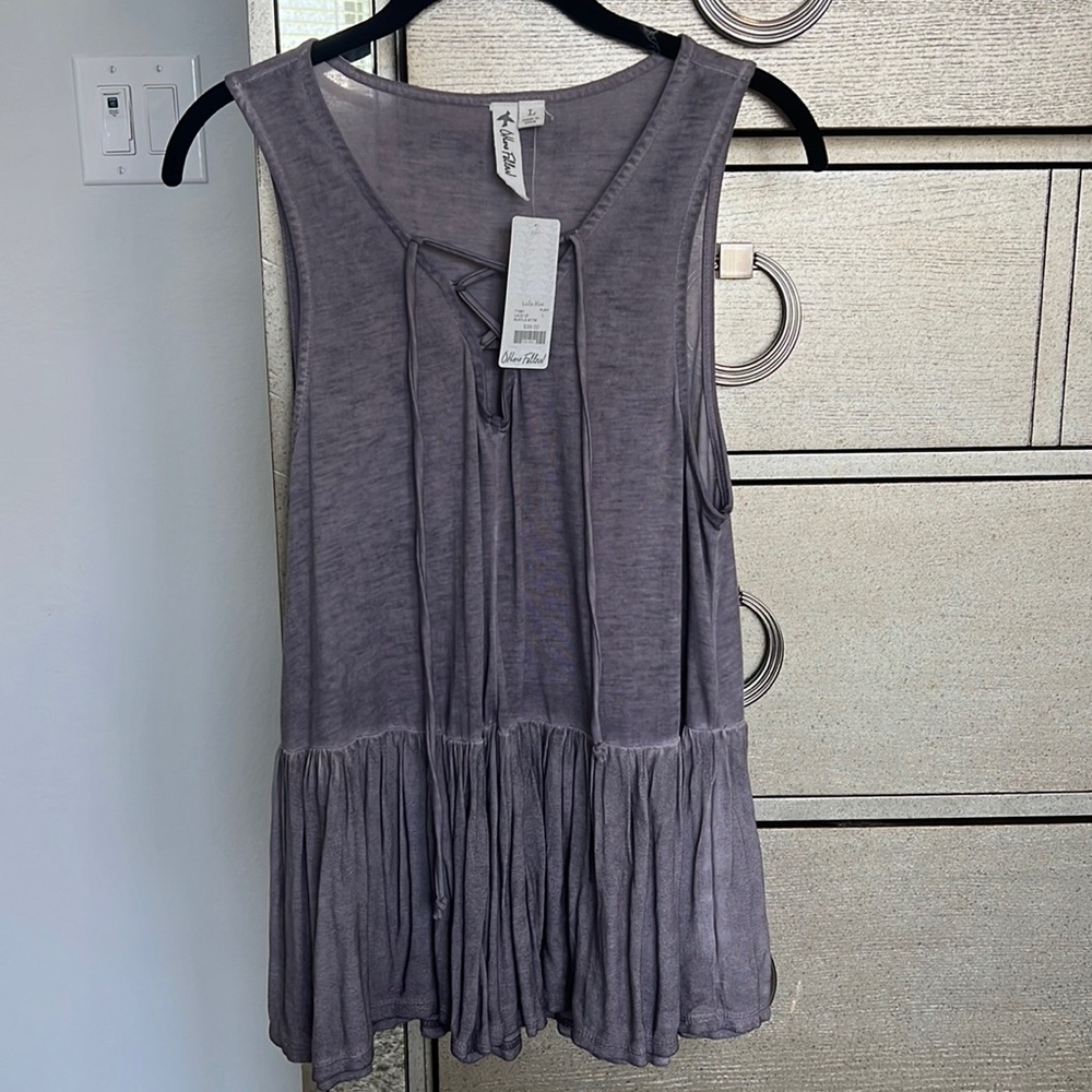 New with tags large tank top with a V-neck scrunch and a flowy bottom